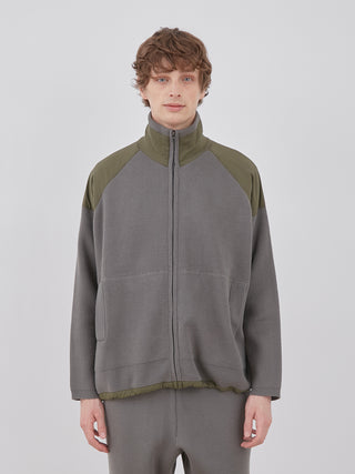 Man wearing OCEANS Plating Moco ECWCS Blouson Jacket in gray and olive.