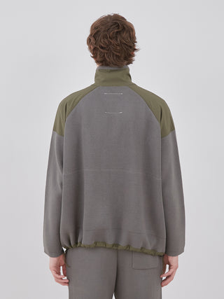 Back view of Plating Moco ECWCS Blouson Jacket in olive and gray by Gelato Pique, featuring a ribbed knit design for men's comfort and style.