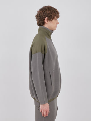 Side view of the OCEANS Plating Moco ECWCS Blouson Jacket highlighting ribbed knit design and casual style.