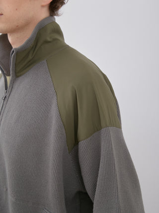 Close-up of OCEANS Plating Moco ECWCS Blouson Jacket with ribbed knit design and khaki shoulder accents, showcasing luxury and functionality.