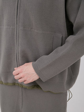 Close-up of the OCEANS Plating Moco ECWCS Blouson Jacket with ribbed knit design, showcasing sleek style and functionality.