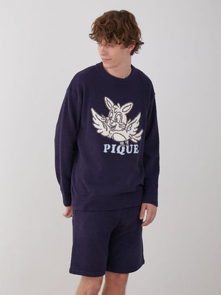 Man wearing KOUSUKE SHIMIZU Men's Air Moco Pullover Sweater in navy, featuring a playful graphic design and matching shorts.