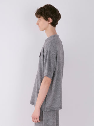 Side view of a man wearing a men's melange knit shirt with a heathered texture, featuring a relaxed fit, by Gelato Pique.
