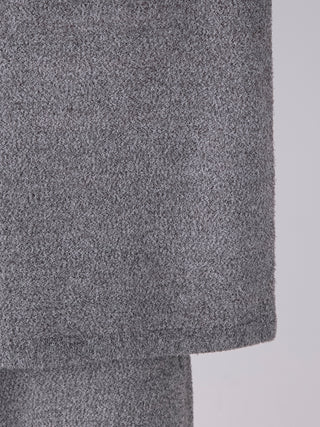 Close-up of a grey melange knit shirt showcasing its textured fabric design.
