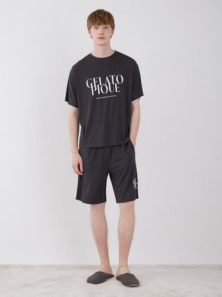 Model wearing black lounge set with Gelato Pique logo, featuring Men's COOL Rayon Comfy Lounge Shorts and matching t-shirt.