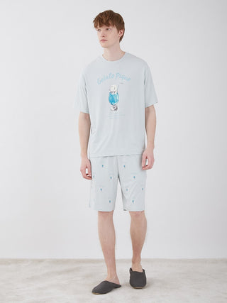 Model wearing Men's Cream Soda Lounge Shorts in light blue with cream soda pattern, by Gelato Pique, made from jade-infused fabric.