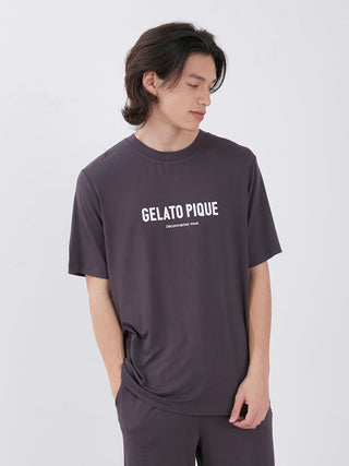 Model wearing men's rayon logo sleepwear t-shirt in dark color, featuring 'Gelato Pique' text, showcasing sustainable comfort and style.