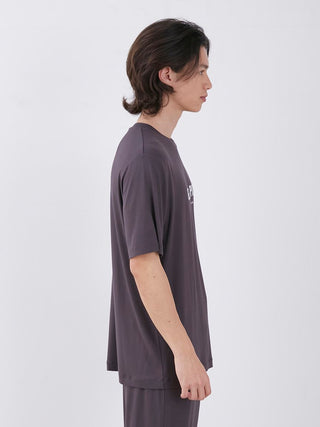 Side view of a man wearing a men's rayon logo sleepwear t-shirt in gray, showcasing its relaxed comfort and sustainable design.