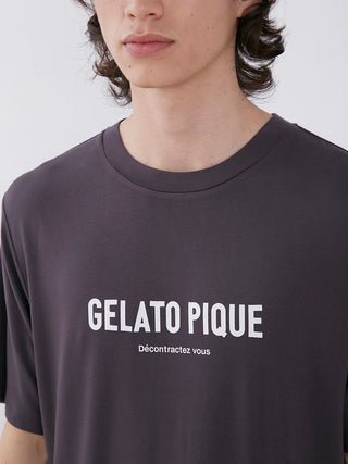 Close-up of a man wearing a dark gray Gelato Pique logo T-shirt, showcasing comfortable and stylish sleepwear fashion.