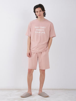 Model wearing pink Sarafree Logo Men's Loungewear Set, featuring cool-to-touch fabric, UV protection, and quick-drying technology.