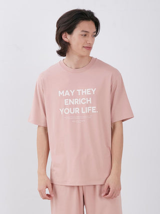 Man wearing Sarafree pink loungewear set with 'May They Enrich Your Life' text on the shirt, perfect for comfort and style.