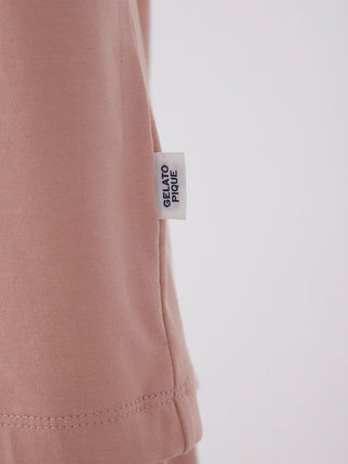 Close-up of pink loungewear fabric with a 'Gelato Pique' label on the seam.