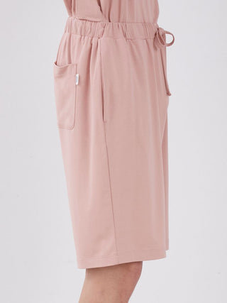 Side view of Sarafree Logo Men's Loungewear Shorts in pink, featuring elastic waistband and side pocket for comfort and style.