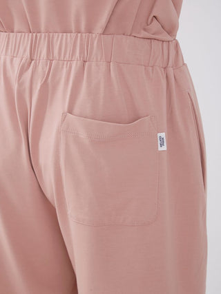 Close-up of Sarafree Logo Mens Loungewear Set in light pink, showing elastic waistband and pocket detail for comfort and style.