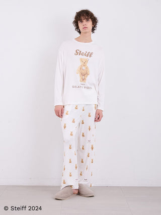 Model wearing Steiff Men's James Long Sleeve Top with teddy bear motif, featuring a relaxed fit and soft ivory fabric.