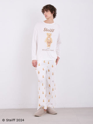 Model wearing Steiff Men's James Long Sleeve Top with teddy bear motif in ivory, paired with matching pants, showcasing comfort and style.