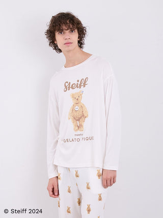 Model wearing Steiff Mens James Long Sleeve Top with teddy bear motif in ivory, showcasing relaxed fit and luxurious fabric.