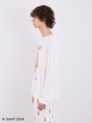 Model wearing Steiff Men's James Long Sleeve Top in soft ivory, side view, showcasing teddy bear motif on premium, breathable fabric.
