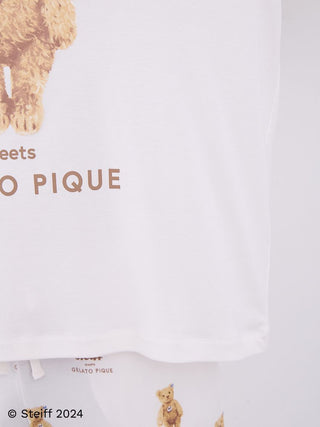 Close-up of Steiff men's ivory long sleeve top featuring teddy bear motif and soft fabric.