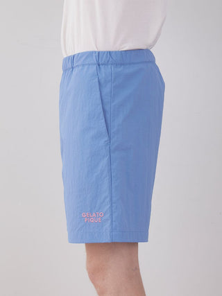 Vibrant blue men's nylon lounge shorts by Gelato Pique USA, ideal for casual summer days, shown on a model.