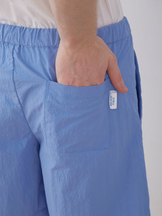 Lightweight blue nylon lounge shorts for men with pocket detail, featuring Gelato Pique branding.