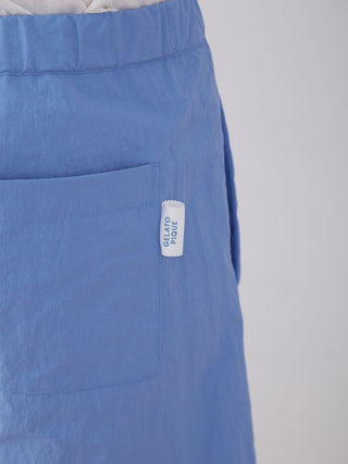 Close-up of Gelato Pique blue nylon lounge shorts with pocket, showcasing brand logo, ideal for comfortable summer style.