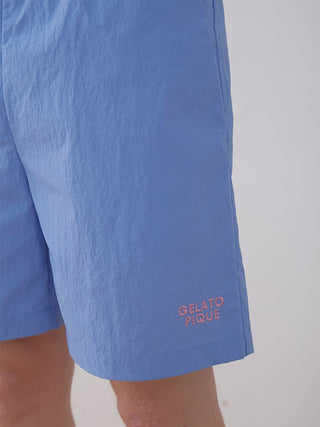Men's vibrant blue nylon lounge shorts with Gelato Pique logo, showcasing summer style and comfort for casual wear.