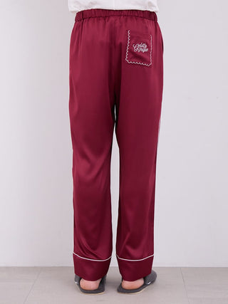 Men's burgundy satin pajama pants with elegant white piping, featuring a comfortable elastic waistband, perfect for cozy nights.
