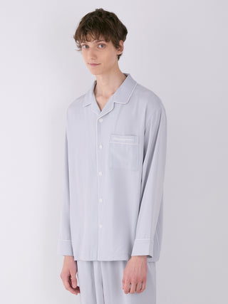 Model wearing Gelato Pique men's satin shirt with a notch collar, button-down design, and front chest pocket, showcasing luxurious loungewear.
