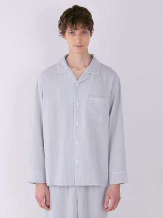 Model wearing men's satin shirt with button-down design, notch collar, and chest pocket by Gelato Pique, ideal for luxurious loungewear.