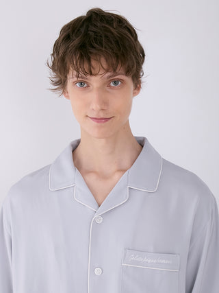 Model wearing Gelato Pique Men's Satin Shirt with notch collar and chest pocket, showcasing luxurious loungewear.