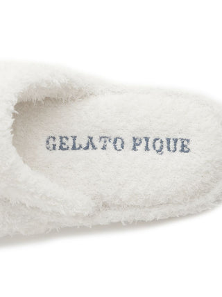 Close-up of Gelato Pique branding on fuzzy white house shoe interior, highlighting soft cozy texture.