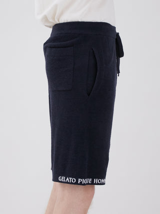 Side view of men's navy blue lounge shorts with pockets and drawstring, made from smooth and lightweight fabric.