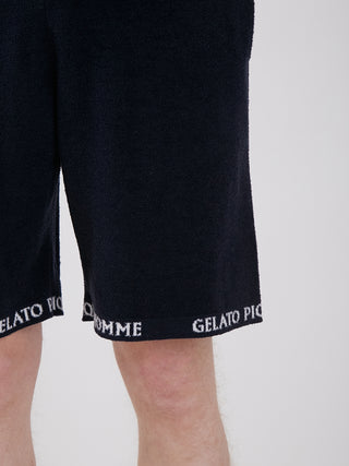 Men's black lounge shorts with 'Gelato Pique' text on hem, made from light and smooth material for comfort and style.