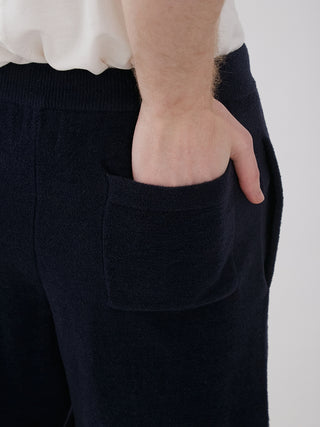 Close-up of a person wearing Men's Smoothie Light Comfy Lounge Shorts in black, showing breathable fabric and side pocket detail.
