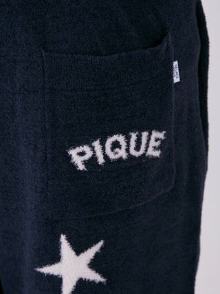 Close-up of Men's Air Mocostar Lounge Shorts in navy with star pattern and Pique logo on the pocket, featuring soft Air Moco fabric.