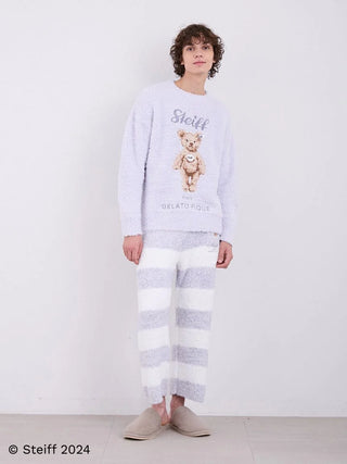 Model wearing Steiff Men's Gelato 2 Border Fuzzy Pajama Pants with wide-striped pattern and soft fluffy knit fabric.