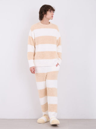 Man in Gelato 2 Border Fuzzy Pajama Pants with cream and white stripes, showcasing soft luxury loungewear.