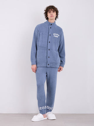 Man wearing blue Gelato Pique powder logo pajama pants and top, showcasing plush comfort and cozy style.