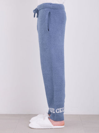 Side view of men's powder logo pajama pants with ultra-soft Gelato Pique fabric, featuring logo at cuffs, worn with white slippers.