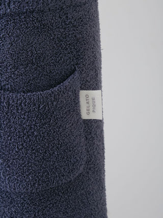 Close-up of Powder Star Jacquard Lounge Pants pocket with Gelato Pique tag, showing plush knit texture in dark blue.