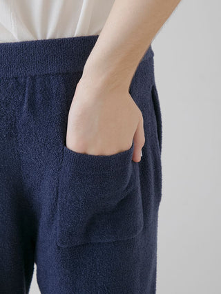 Person wearing navy Temperature-Control Smoothie Lounge Pants with hand in pocket, showcasing ultra-soft breathable fabric by Gelato Pique USA