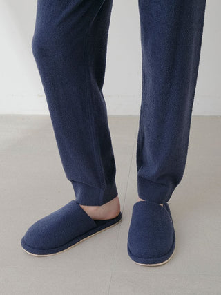 Person wearing navy Temperature-Control Smoothie Lounge Pants and matching slippers on a light floor.
