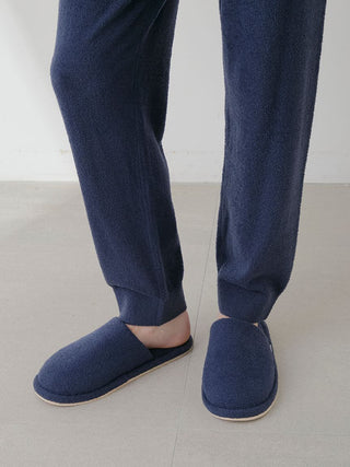 Person wearing Gelato Pique Temperature-Control Smoothie Lounge Pants with cozy slippers, showcasing comfortable and breathable fabric.