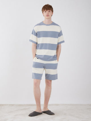 Model wearing Smoothie Lite 2 Border Men's Short Sleeve Sweatshirt, blue and white stripes, perfect for stylish summer lounging.