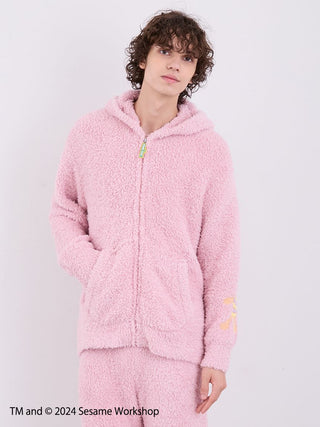 Man wearing pink fluffy Sesame Street Elmo hoodie and shorts loungewear set by Gelato Pique.