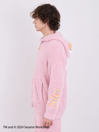 Men's Elmo hoodie from Sesame Street loungewear set, featuring fluffy pink fabric and Elmo design, side profile view.