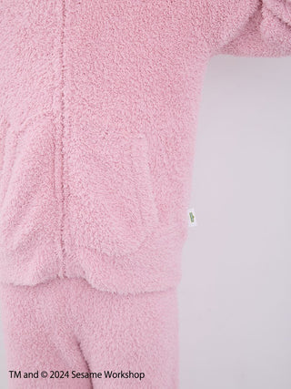 Close-up of pink fuzzy loungewear set with hoodie and shorts from Sesame Street collection by Gelato Pique.