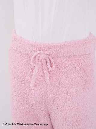 Close-up of fluffy pink loungewear shorts from Sesame Street Men's Elmo Hoodie and Shorts Set, featuring a drawstring waist.