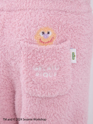 Close-up of pink fluffy shorts with Elmo design, featuring a pocket, from the Sesame Street Men's Elmo Loungewear Set by Gelato Pique.